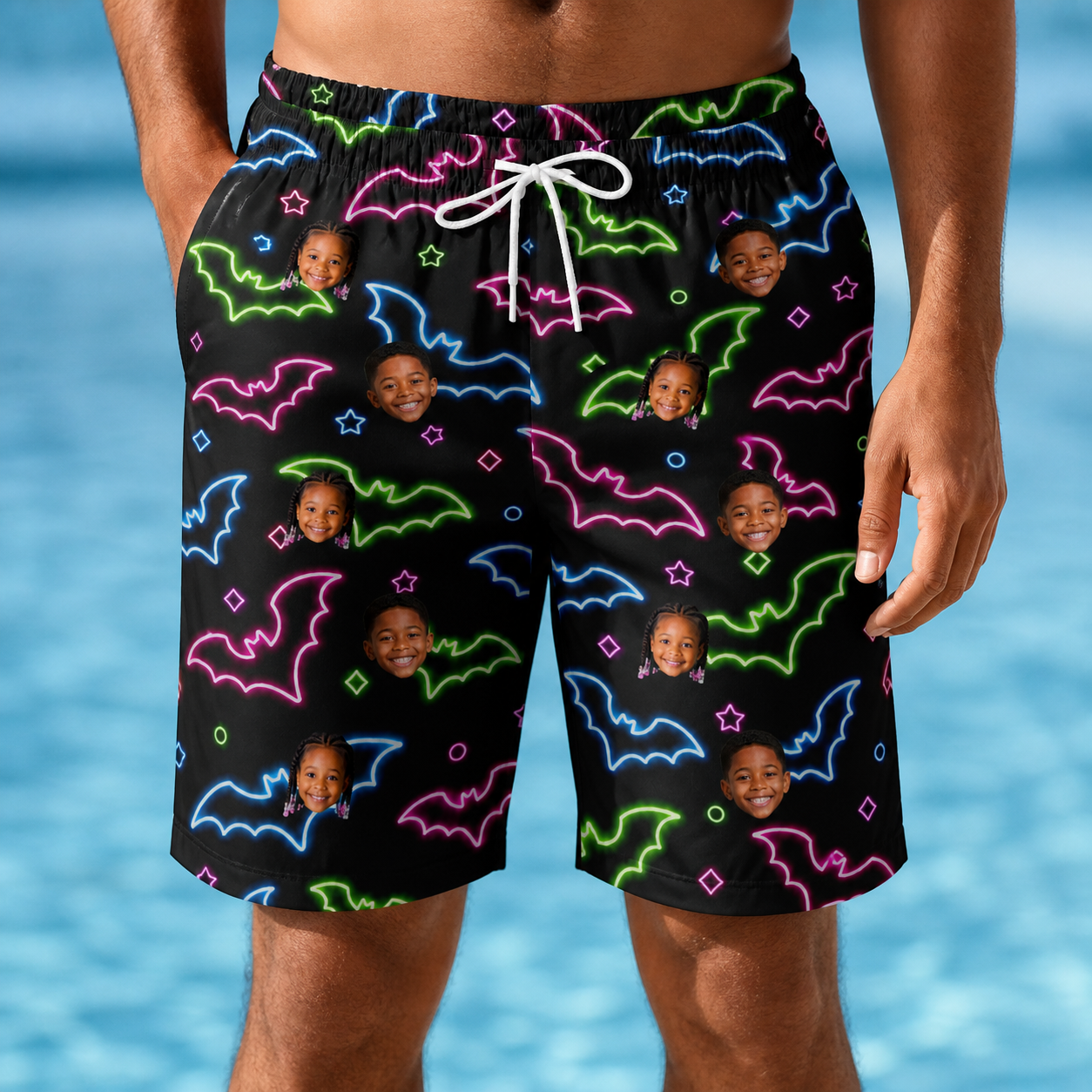 Model wearing Men's Batty Night Custom Face Beach Shorts printed with kids' faces
