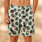 Model wearing Men's Verdant Vacation Custom Face Beach Shorts printed with kids' faces