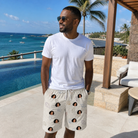 Real-life photo of someone wearing Men's Bivalve Bounce Custom Face Beach Shorts — custom faces printed all-over