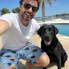 Selfie with the pet whose face is printed all over this Men's Aero Barkers Custom Dog Face Beach Shorts