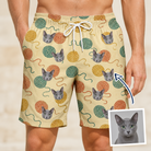 Man wearing Men's Mewton Balls Custom Cat Face Beach Shorts — custom faces printed all-over