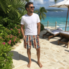 Real-life photo of someone wearing Men's Christmas Cuffs Custom Face Beach Shorts — custom faces printed all-over