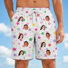 Model wearing Men's Confetti Comets Custom Face Beach Shorts printed with kids' faces