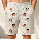 Model wearing Men's Brilliant Bachelorette Custom Face Beach Shorts printed with kids' faces
