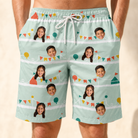 Model wearing Men's Aisle Antics Custom Face Beach Shorts printed with kids' faces
