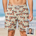 Man wearing Men's Indie Optics Custom Face Beach Shorts — custom faces printed all-over