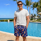 Real-life photo of someone wearing Men's July Quarters Custom Face Beach Shorts — custom faces printed all-over