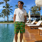 Real-life photo of someone wearing Men's Course Cruisers Custom Face Beach Shorts — custom faces printed all-over