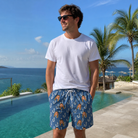 Real-life photo of someone wearing Men's Treble Trouble Custom Face Beach Shorts — custom faces printed all-over