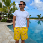 Real-life photo of someone wearing Men's Cavendish Capers Custom Face Beach Shorts — custom faces printed all-over