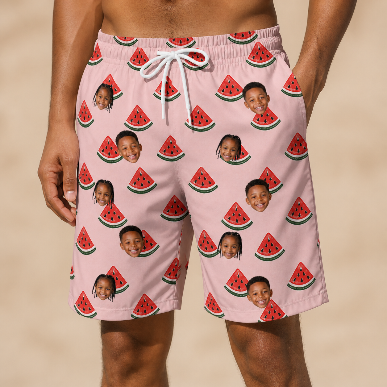Model wearing Men's Watermelon Whimsy Custom Face Beach Shorts printed with kids' faces