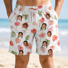 Model wearing Men's Anthurium Antics Custom Face Beach Shorts printed with kids' faces