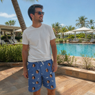 Real-life photo of someone wearing Men's Mako Minnows Custom Face Beach Shorts — custom faces printed all-over