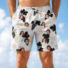 Model wearing Men's Juicy Jewels Custom Face Beach Shorts printed with kids' faces