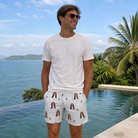 Real-life photo of someone wearing Men's Berry Merry Custom Face Beach Shorts — custom faces printed all-over