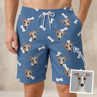 Man wearing Men's Waggle Wafers Custom Dog Face Beach Shorts — custom faces printed all-over