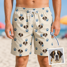 Man wearing Men's Puppy Prints Custom Dog Face Beach Shorts — custom faces printed all-over