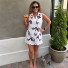 Full-length photo with the pet printed all over this Women's Clawful Feathers Custom Cat Face V-Neck Dress