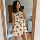 Real-life photo of someone wearing Women's Winged Whispers Custom Face Tank Dress — custom faces printed all-over