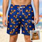 Man wearing Men's Orange Oddities Custom Cat Face Beach Shorts — custom faces printed all-over