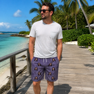 Real-life photo of someone wearing Men's Cemetery Chuckles Custom Face Beach Shorts — custom faces printed all-over