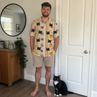 Full-length photo with the pet printed all over this Men's Webbed Bones Custom Cat Face Polo Shirt