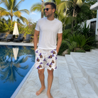 Real-life photo of someone wearing Men's Cauldron Crowns Custom Face Beach Shorts — custom faces printed all-over