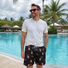 Real-life photo of someone wearing Men's Holly Hush Custom Face Beach Shorts — custom faces printed all-over