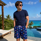 Real-life photo of someone wearing Men's Boxed Bliss Custom Face Beach Shorts — custom faces printed all-over