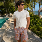 Real-life photo of someone wearing Men's Toot Suite Custom Face Beach Shorts — custom faces printed all-over
