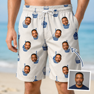 Man wearing Men's Cupcake Countdown Custom Face Beach Shorts — custom faces printed all-over