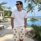 Real-life photo of someone wearing Men's Toast Tiaras Custom Face Beach Shorts — custom faces printed all-over