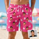 Man wearing Men's Tiered Tease Custom Face Beach Shorts — custom faces printed all-over