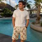 Real-life photo of someone wearing Men's Flag Fandango Custom Face Beach Shorts — custom faces printed all-over