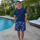 Real-life photo of someone wearing Men's Rebel Reflectors Custom Face Beach Shorts — custom faces printed all-over