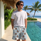 Real-life photo of someone wearing Men's Ivory Coo Custom Face Beach Shorts — custom faces printed all-over